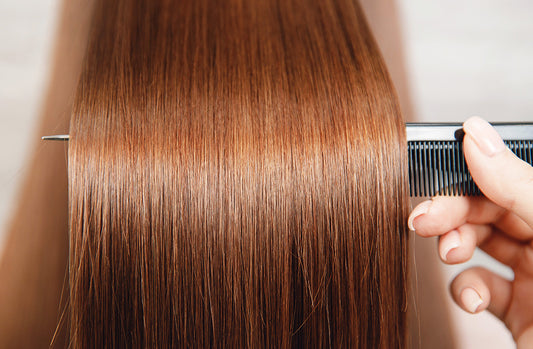Long shiny auburn hair with hand and comb