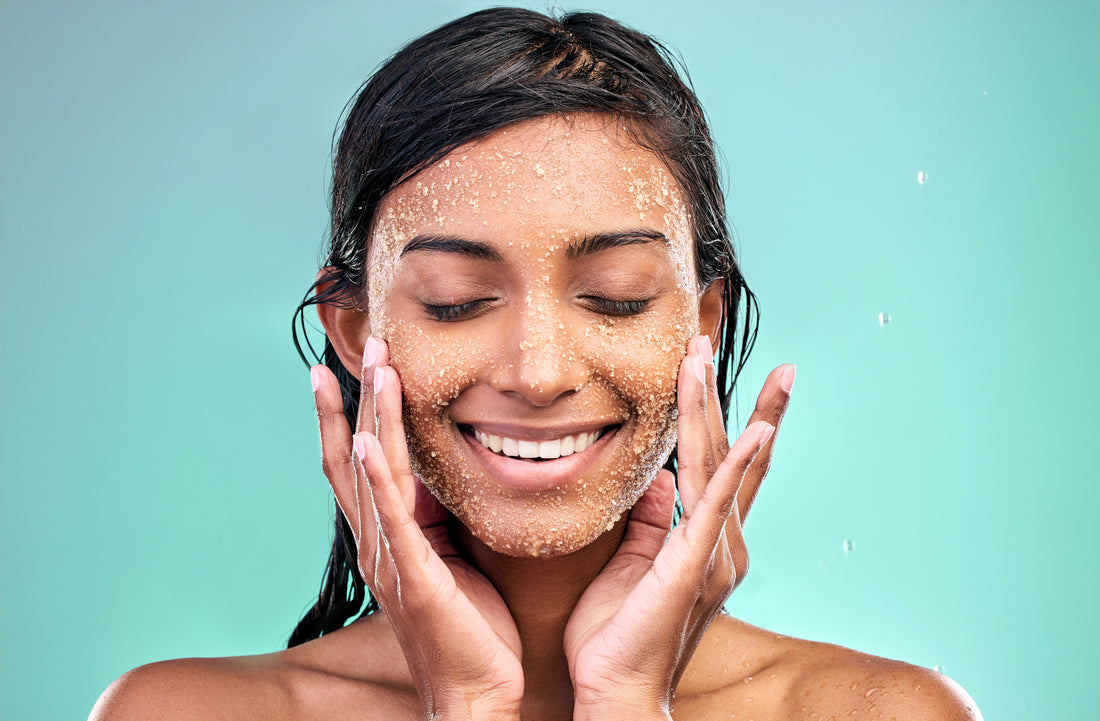 woman exfoliating her face 